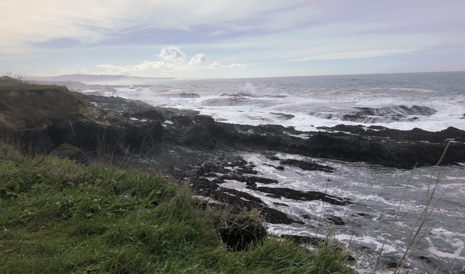 View of ocean and rocks with nice sky